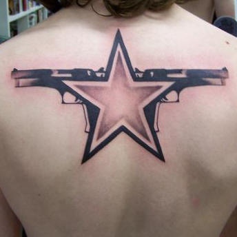 Star and pistols tattoo on back