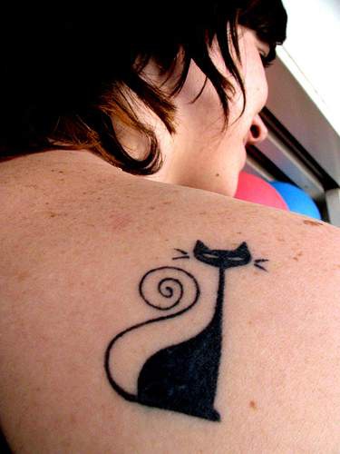 Stylish black cat tattoo on shoulder