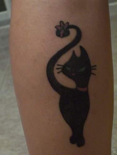 Black cat with flower in tail tattoo