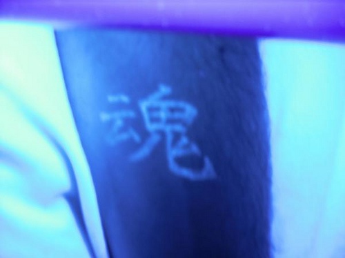 Chinese hieroglyphs glowing tattoo