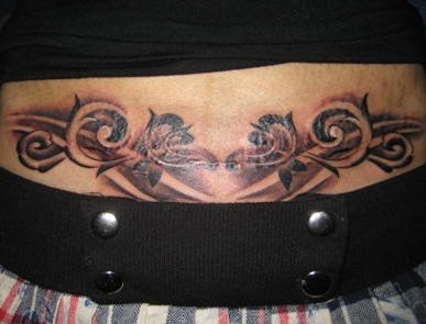 Black lower back tattoo design, curled branches