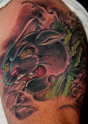 Black panther in bamboo forest tattoo