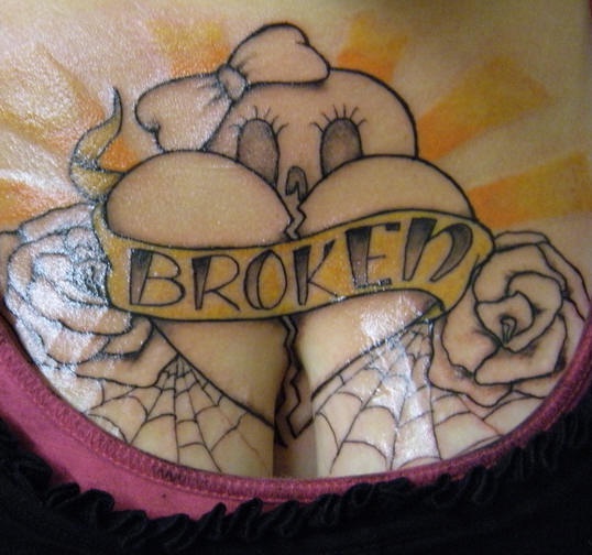 Broken heart with web and roses chest tattoo