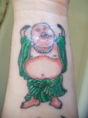 Smiling buddha in green clothes tattoo