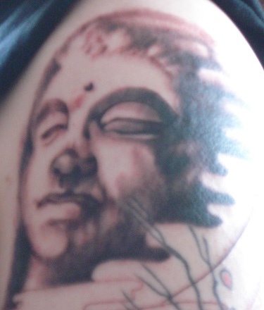 Stone buddha face tattoo