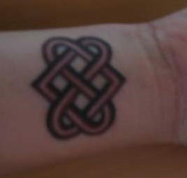 Buddhist love knot wrist tattoo
