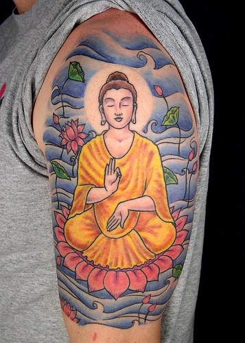 Meditating buddha on lotus coloured tattoo