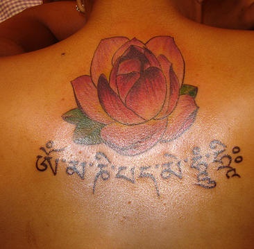 Lotus and buddhist mantra tattoo