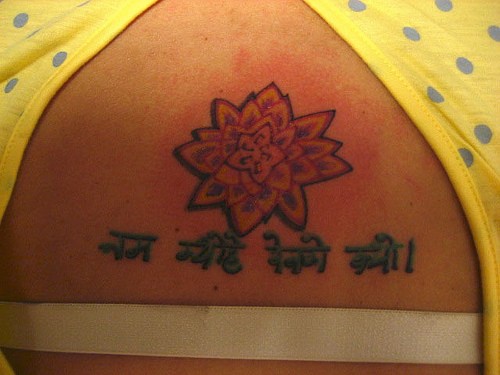 Buddhist mantra with lotus  tattoo