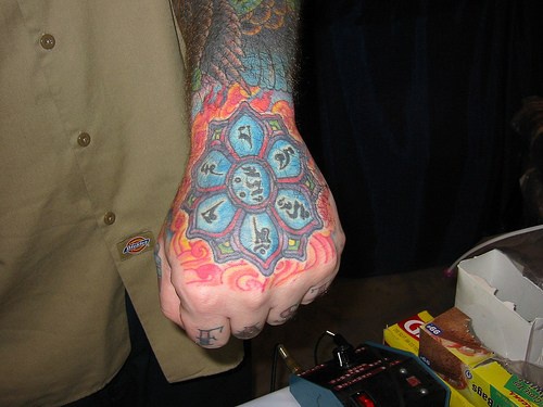 Buddhist blue lotus arm tattoo