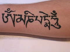 Hindu buddhist mantra tattoo on arm