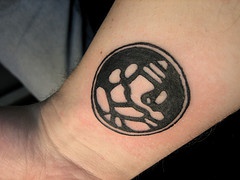 Buddhist symbol tattoo on wrist