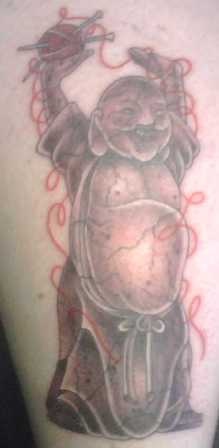 Laughing buddha with ball of string tattoo