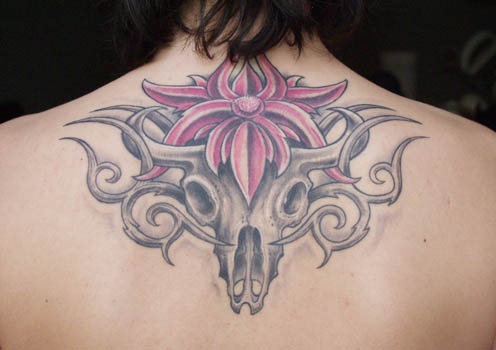 Bull skull with tracery and flower tattoo
