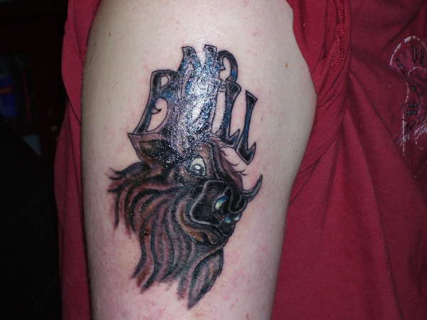 Angry hairy bull tattoo on arm
