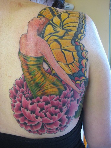 Colourful butterfly lady on flowers tattoo