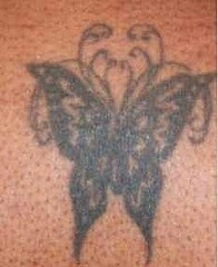 Black ink butterfly tattoo