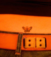 Small butterfly tattoo on tail base