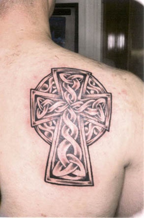 Stone celtic cross tattoo on shoulder