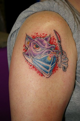 Cartoonish doctor tattoo on shoulder