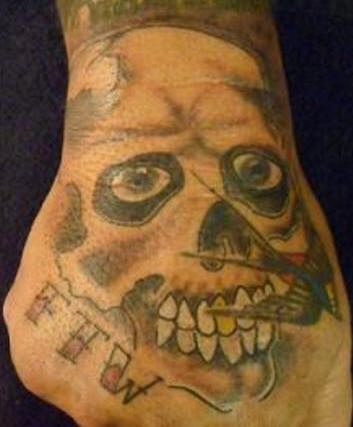 Skull with golden tooth tattoo