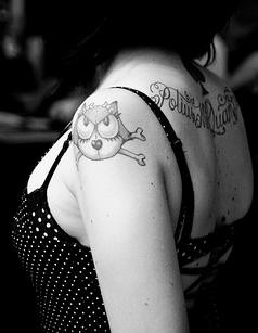 gatto felix con ossa tatuaggio sulla spalla