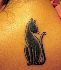 Elegant black cat shaped tattoo