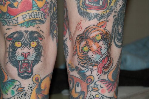 Roaring panther and tiger coloured tattoo