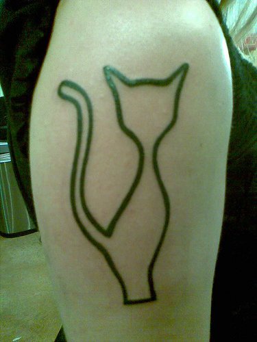 Minimalistic cat silhouette tattoo