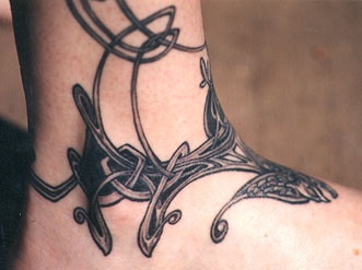Celtic tribal pattern on feet tattoo