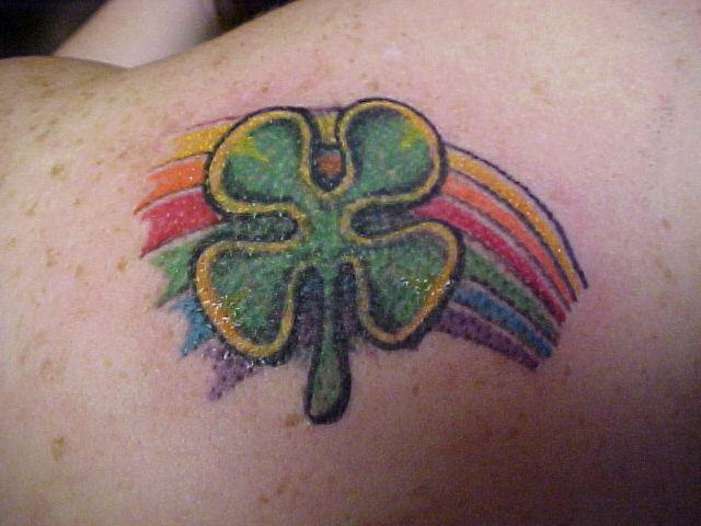 Four leaf clover with rainbow coloured tattoo