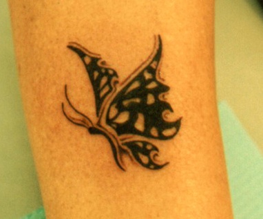 Tribal tracery butterfly wings tattoo