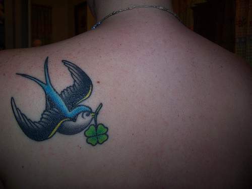 Sparrow with four leaf clover tattoo