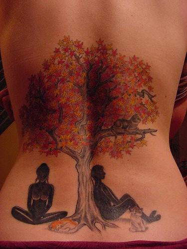 Back tattoo with big autumn tree and two people