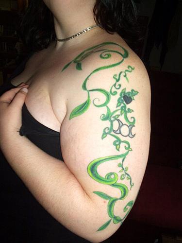 Green vine tree tattoo on shoulder and arm