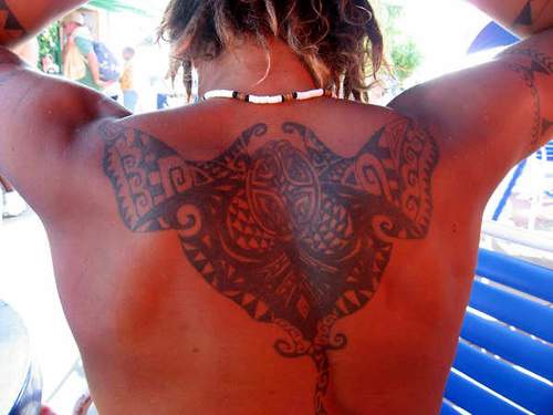 Celtic knot tracery tattoo on back