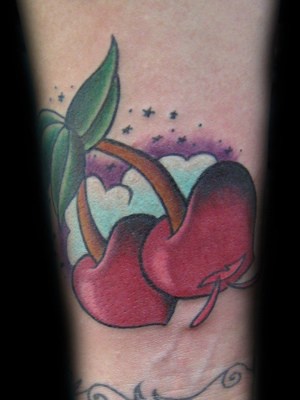 Large red-ripe cherry coloured tattoo