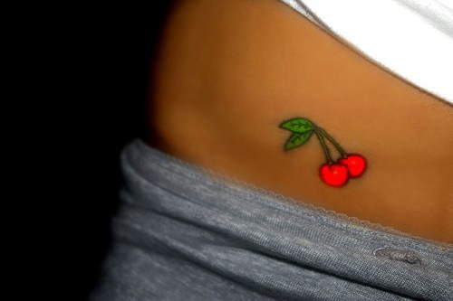 Bright red cherry tattoo