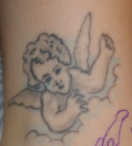 Conture cherub in clouds tattoo