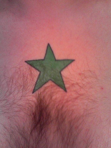 Green star chest tattoo