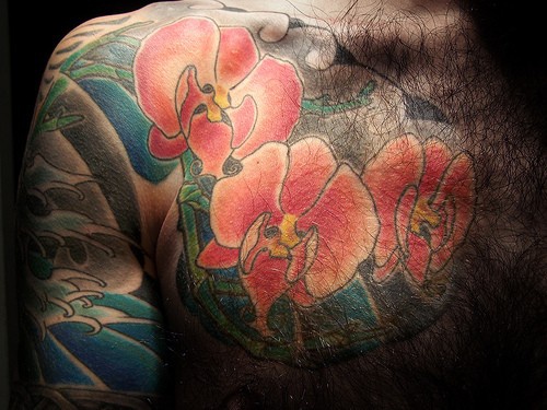 Orchid chest piece tattoo