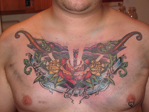 Decorated rose chest piece tattoo