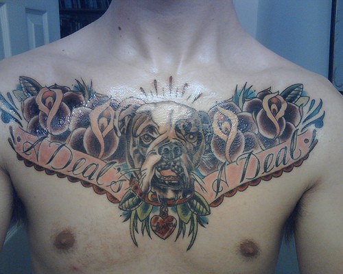 Dog with flowers chest tattoo