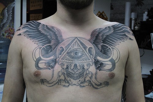 All-seeing winged eye chest tattoo