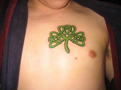 Green patrick's leaf chest tattoo