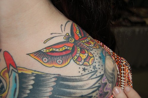 Colourful butterfly chest tattoo
