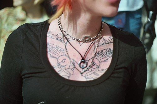 Uncolored heart & bird chest tattoo