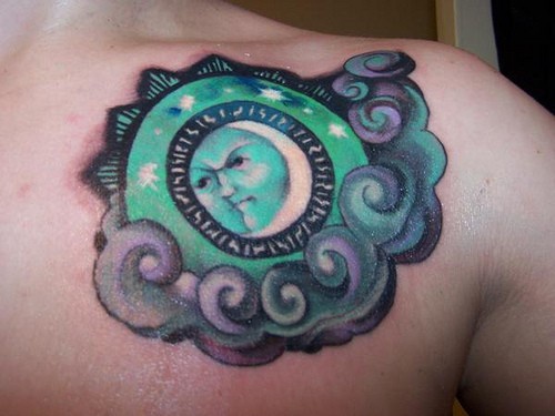 Green all-seeing eye chest tattoo
