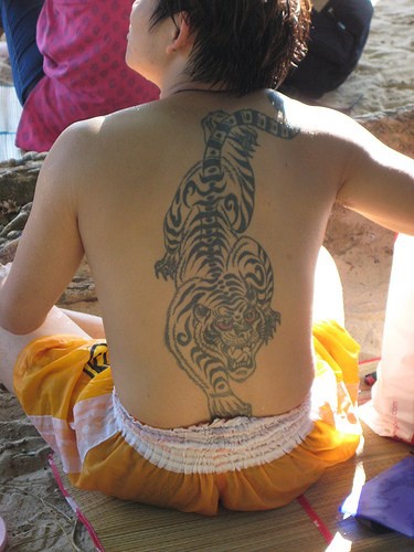 Chinese style crawling tiger tattoo on back