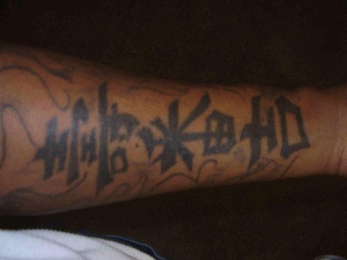 Chinese hieroglyphs arm tattoo